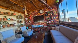 a restaurant with a brick wall with a table and chairs at Uchisar Cave House in Uçhisar