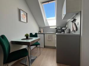 a small kitchen with a table and a window at Main Square Olive Studio in Trnava