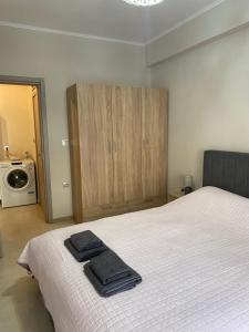 a bedroom with a bed with two towels on it at Unique Centro Apartment in Kilkis