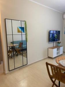 a living room with a sliding glass door with a table at Unique Centro Apartment in Kilkis