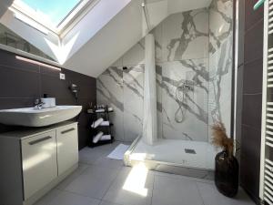 a bathroom with a sink and a shower with a window at Main Square Olive Studio in Trnava +9 photos