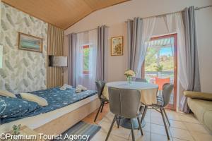 a hotel room with a bed and a table and chairs at Zdenko in Metajna