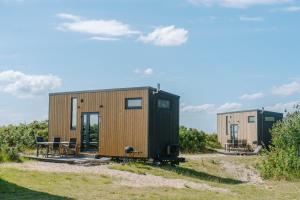 a tiny house on a trailer in a field at Tiny Seaside - Kegnæs in Østerby