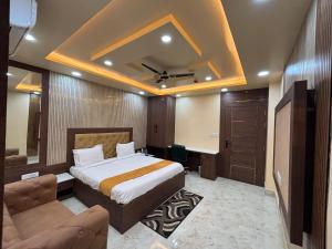 a bedroom with a bed and a desk and a couch at S K Tower Hotels in Nawāda