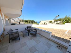 a patio with chairs and tables on a roof at Ca' Luci in Marina San Gregorio
