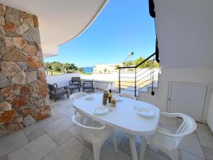 a white table and chairs on a patio at Ca' Luci in Marina San Gregorio
