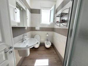 a bathroom with a sink and a toilet at Ca' Luci in Marina San Gregorio +30 photos