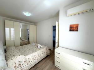 a bedroom with a bed and a large mirror at Ca' Luci in Marina San Gregorio