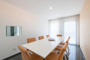 a dining room with a white table and chairs at Villa Monchique in Monchique +53 photos