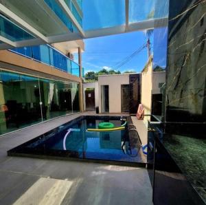 a house with a pool with a frisbee in it at terraço do peró cabo frio pousada in Cabo Frio