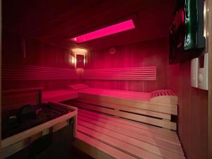 a sauna with pink lights in a red room at Haus Farbenklang in Zwiesel