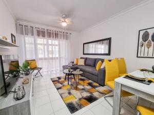 a living room with a couch and a table at Apartment Praia Rocha Candimar Sunflower in Portimão