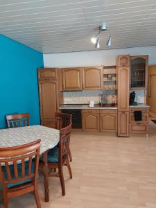 a kitchen with wooden cabinets and a table and chairs at Ferienwohnung am Stiefel in Sankt Ingbert