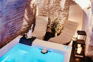 a room with a swimming pool and two chairs at Moira Suite in Bitonto