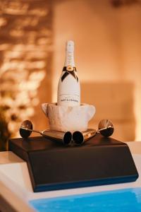 a bottle of champagne sitting on a table with spoons at Moira Suite in Bitonto