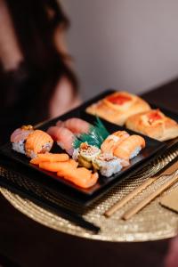 a plate of sushi on a table with chopsticks at Moira Suite in Bitonto +32 photos
