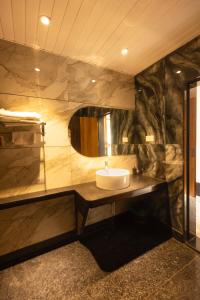 a bathroom with a sink and a mirror at Nautical 9 Beach Retreat in Kundapur