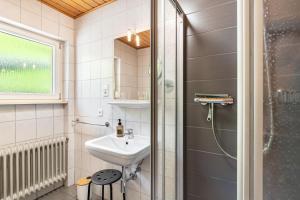a bathroom with a sink and a shower at Spinnertonihof in Bad Peterstal +80 photos