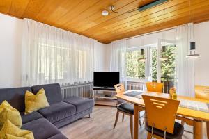a living room with a couch and a table at Spinnertonihof in Bad Peterstal