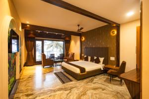 a bedroom with a bed and a television in it at Nautical 9 Beach Retreat in Kundapur