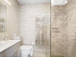 a bathroom with a toilet and a glass shower at Little Tara, Ballyconneely in Ballyconneely +28 photos