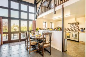 a kitchen and dining room with a table and chairs at 3 Bed in Little Ellingham oc-2147 in Rockland Saint Peter