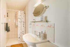 a white bathroom with a sink and a mirror at 3 Bed in Little Ellingham oc-2147 in Rockland Saint Peter +22 photos