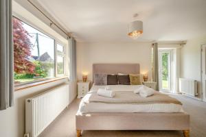 a bedroom with a large bed with towels on it at 4 Bed in Bideford oc-76452 in Parkham
