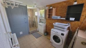 a bathroom with a washing machine and a shower at Gîte Champgrand in Loriol-sur-Drôme