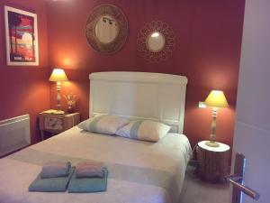a bedroom with a bed with two towels on it at La Villa Belle in Biscarrosse +7 photos