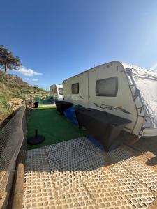 a camper parked on the side of a road at Little Hideaway Deluxe in Costa da Caparica