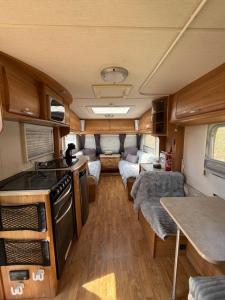 a kitchen and living room of an rv at Little Hideaway Deluxe in Costa da Caparica