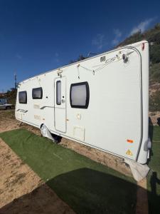 a white trailer is parked on the grass at Little Hideaway Deluxe in Costa da Caparica +13 photos