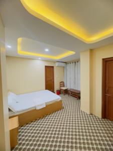 a hotel room with a bed and a table at Shrestha Hotel And Lodge in Dhāding