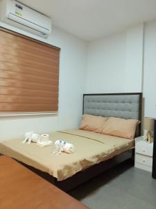 a bedroom with a bed with towels on it at Axc cozy inn in Olongapo