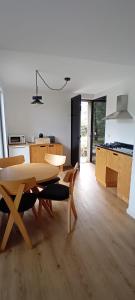 a kitchen and dining room with a table and chairs at Ninho da Avó Selvagem in Montalegre