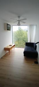 a living room with a couch and a table at Ninho da Avó Selvagem in Montalegre