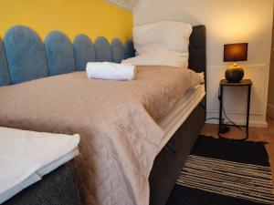 a bedroom with two beds with a blue headboard at GlanzExperts Auszeit bei Berlin Balkon Kicker & DisneyPlus in Zossen