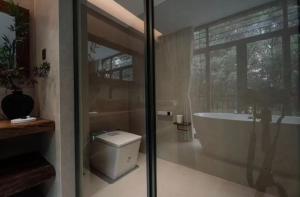 a bathroom with a tub and a toilet at Wuzhen FortuneCourt Hotel in Jiaxing +42 photos