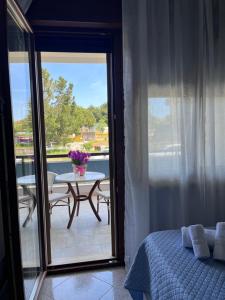 a bedroom with a bed and a table and a balcony at B&B a casa di Sonia in Termoli