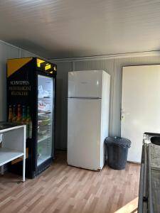 a white refrigerator sitting in a room next to a floor at Adrasan Camping in Kumluca
