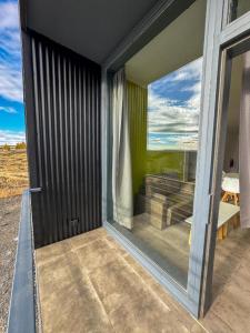 a glass door of a house with a view at Simple Aparts in El Calafate +57 photos