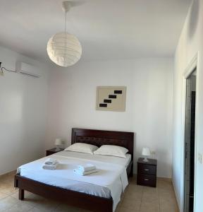 a bedroom with a bed and a pendant light at Hotel Villa Ruci in Ksamil +34 photos