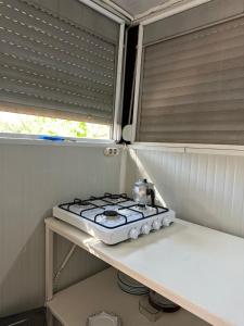 a stove top in a kitchen with a window at Adrasan Camping in Kumluca
