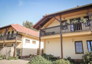 a house with a balcony on the side of it at Ekofarma Sádky in Uherské Hradiště +16 photos