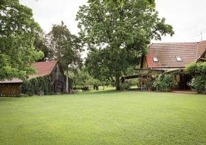 a large yard with a barn and a building at Ekofarma Sádky in Uherské Hradiště