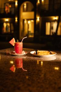 a table with two plates of food and a cup on it at Nautical 9 Beach Retreat in Kundapur +17 photos