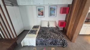 a small bedroom with a bed in a room at ONLY4VIEW Beach Front in Sainte-Anne