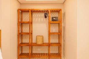 a shelf in the corner of a room at Almaê Pousada in Matinhos