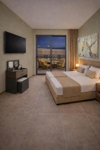 a bedroom with a large bed and a television at Maritina Apartments in Ixia +73 photos